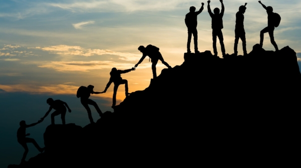 Group of people on peak mountain climbing helping team work , travel trekking success business concept