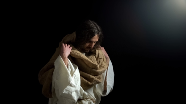 Biblical prophet with lowered head standing in darkness, spiritual confession